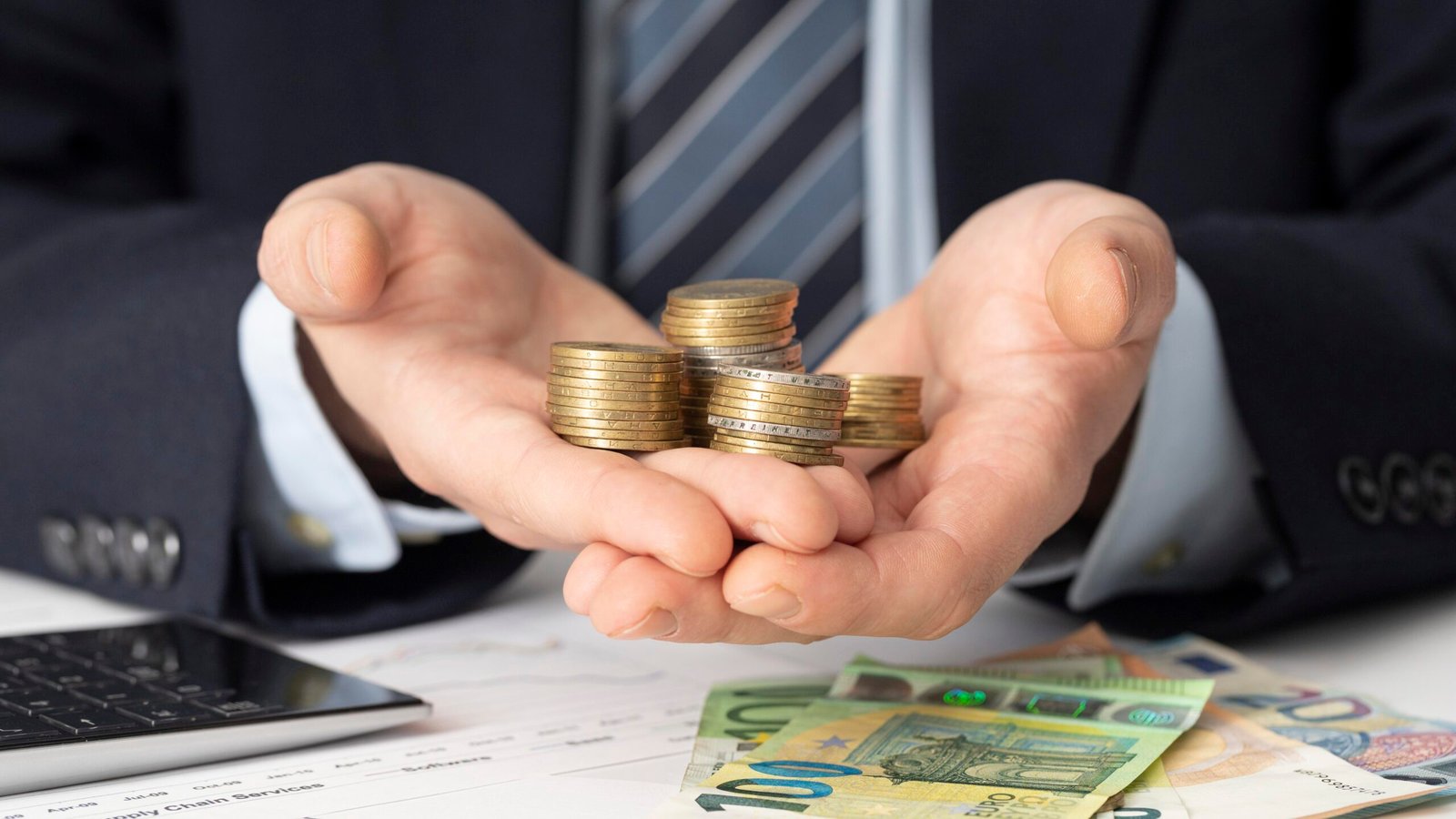 freepik.com ,2026,businessman-holding-bunch-coins